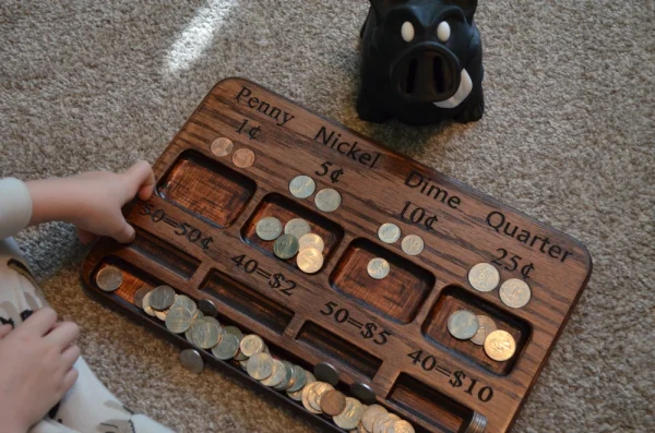 child playing with kid's coin counter and separator