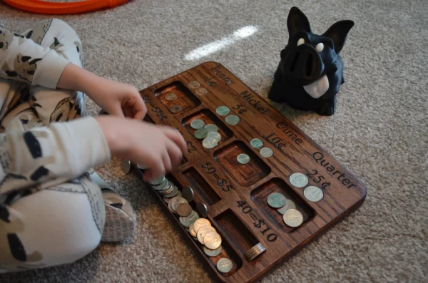 child playing with kid's coin counter and separator