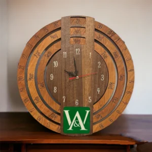 Wooden clock with rings for Month, Day, & Date surrounding an analog clock. Green and White Logo of W A